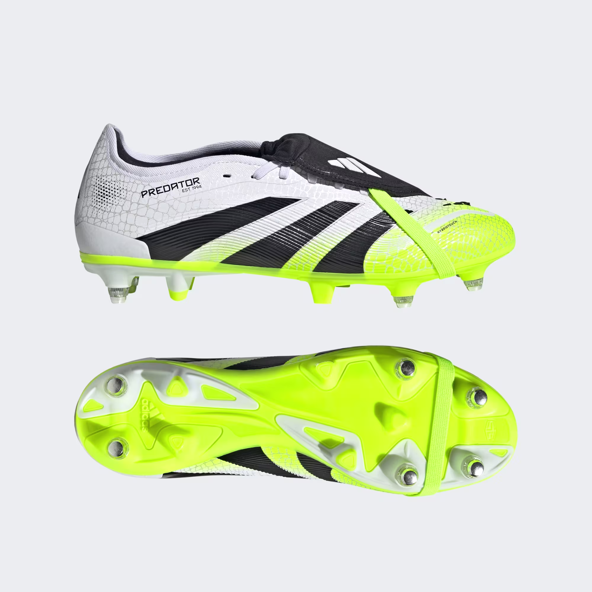 Football boot studs on floodlit pitch at night